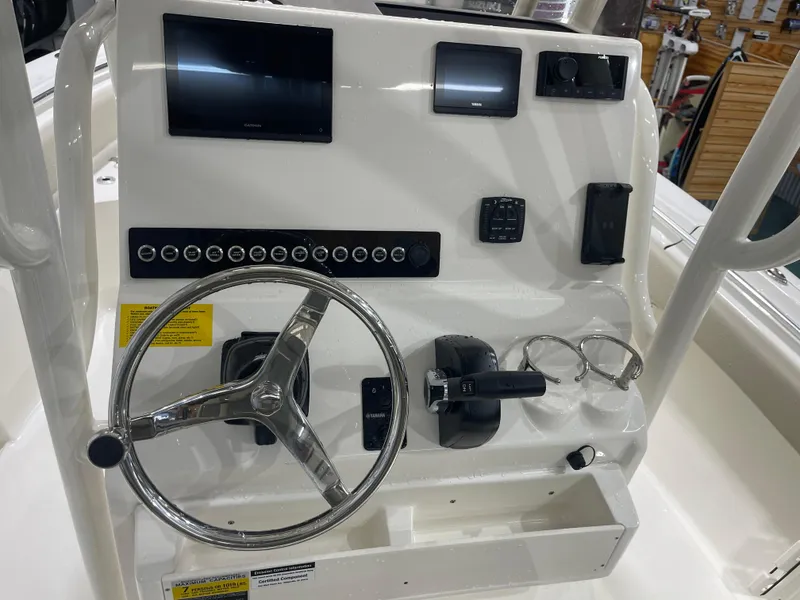 Slide: The Image of 2025 Key West 219fs boat dashboard with steering wheel and electronic controls. - 27