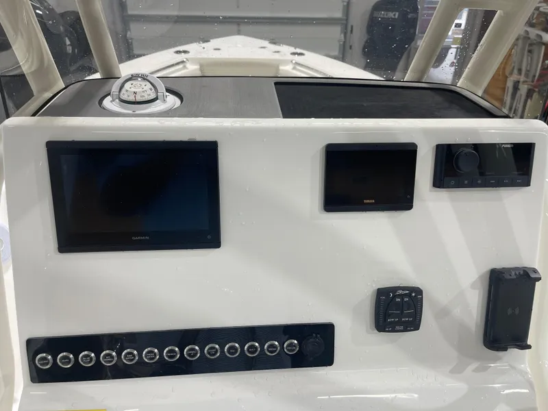 Slide: The Image of Key West 219fs 2025 boat dashboard with Garmin and Yamaha displays. - 28