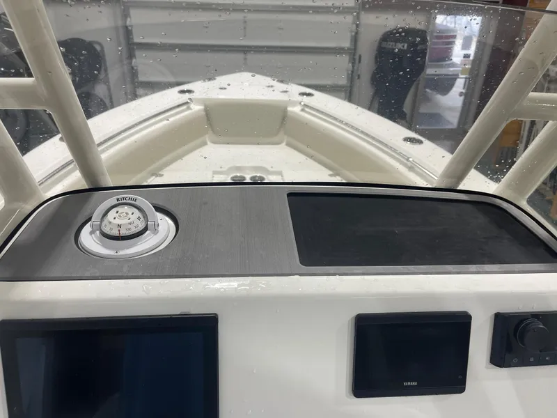 Slide: The Image of 2025 Key West 219fs boat dashboard with compass and electronic displays. - 29