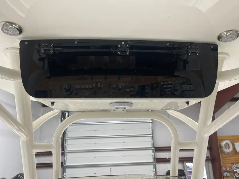 Slide: The Image of 2025 Key West 219fs boat console with black panel and overhead lights. - 30
