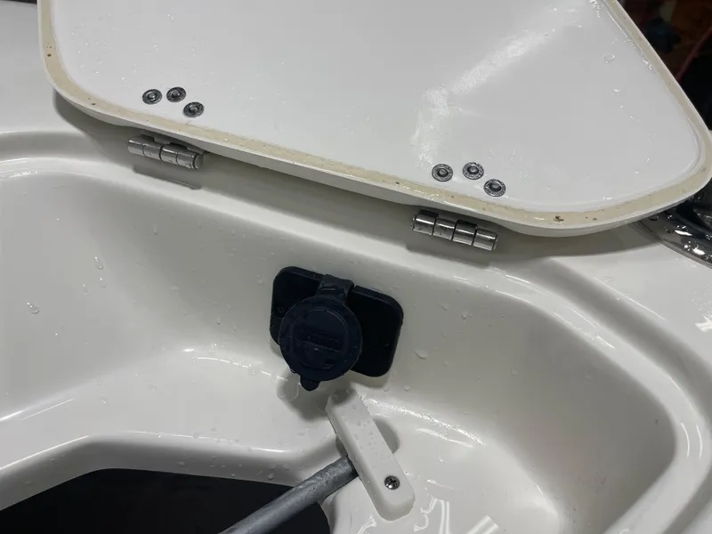 Slide: The Image of 2025 Key West 219fs boat compartment with open hatch and water droplets. - 35