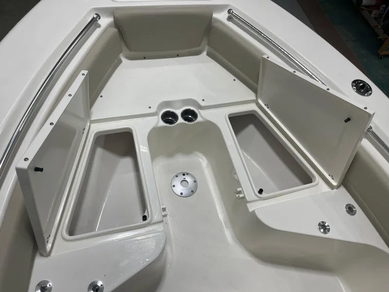 Slide: The Image of 2025 Key West 219fs boat interior with open storage compartments and cup holders. - 36