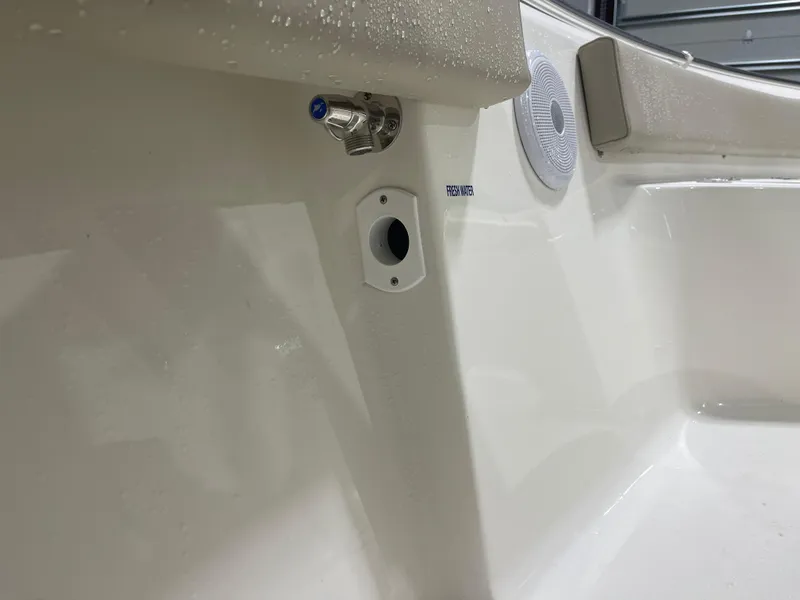 Slide: The Image of 2025 Key West 219fs boat interior detail with fresh water outlet and speaker. - 40