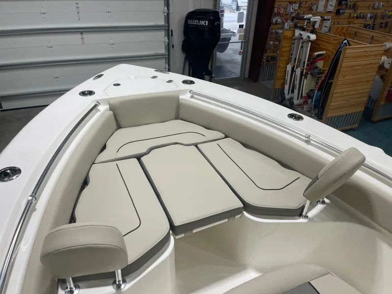 Slide: The Image of 2025 Key West 219fs boat interior with cushioned seating in a showroom. - 42