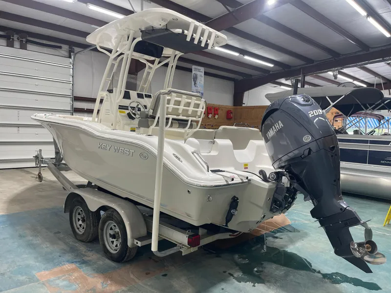 Slide: The Image of 2025 Key West 219fs boat with Yamaha 200 engine in a showroom. - 7