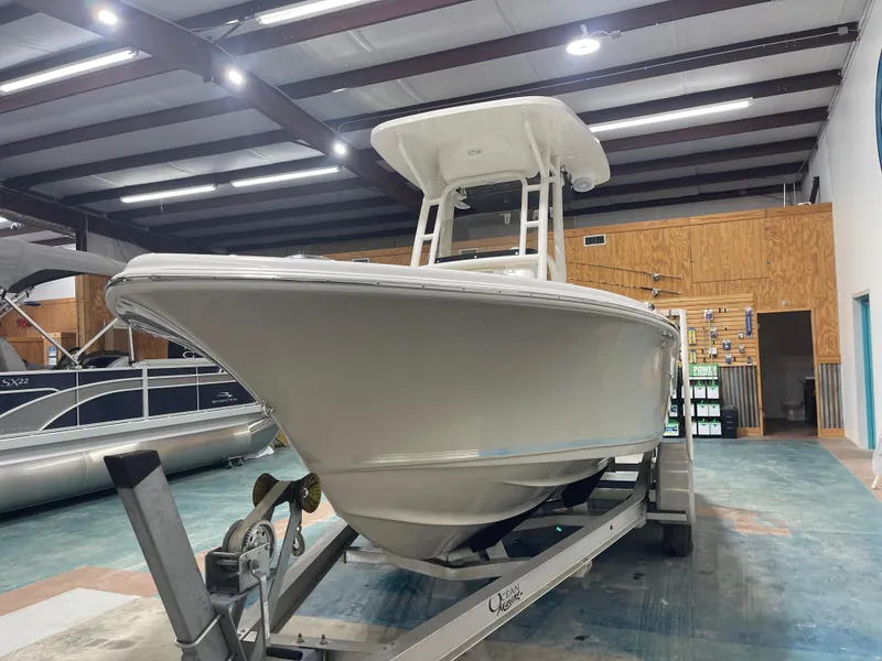 Slide: The Image of 2025 Key West 219fs boat on trailer in indoor showroom. - 8