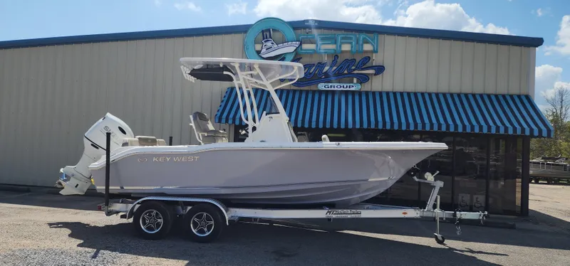 Slide: The Image of 2024 Key West 219fs boat on trailer outside Ocean Marine Group. - 1