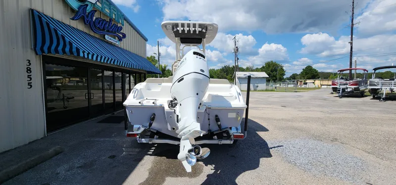 Slide: The Image of 2024 Key West 219fs boat displayed outside dealership under blue sky. - 11