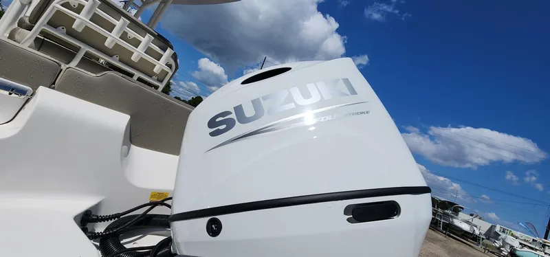 Slide: The Image of 2024 Key West 219fs boat with Suzuki outboard motor under a clear blue sky. - 14