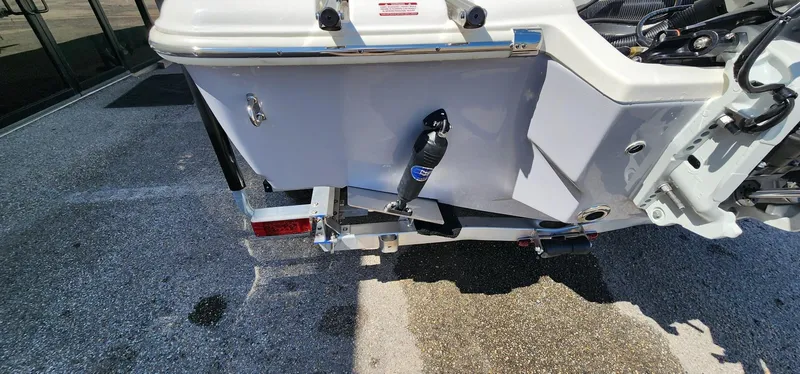 Slide: The Image of 2024 Key West 219fs boat rear view, showcasing hull and motor mount details. - 15