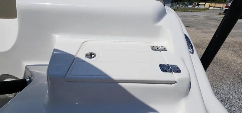 Slide: The Image of 2024 Key West 219fs boat storage compartment with secure latch and hinges. - 17