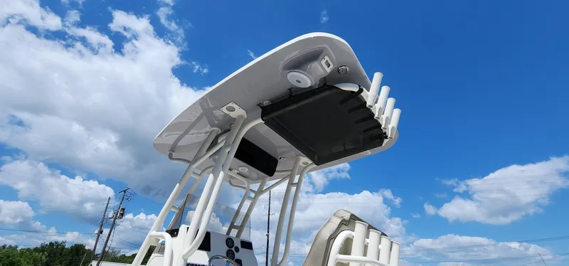 Slide: The Image of 2024 Key West 219fs boat with T-top against a blue sky. - 19