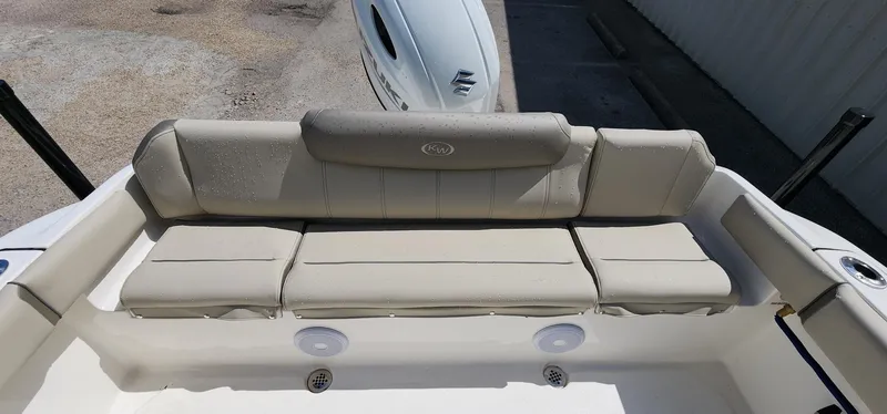 Slide: The Image of 2024 Key West 219fs boat with beige cushioned seating in the rear. - 20