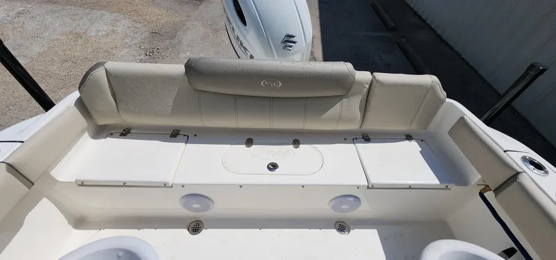 Slide: The Image of 2024 Key West 219fs boat interior with cushioned seating and storage compartments. - 21