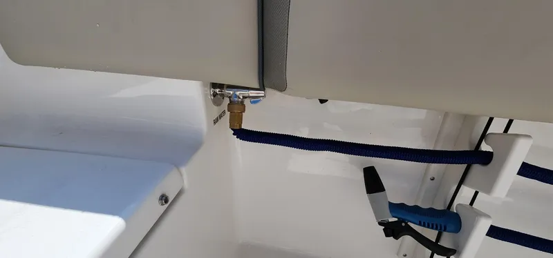 Slide: The Image of 2024 Key West 219fs boat interior with hose and tool storage. - 23