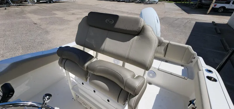 Slide: The Image of 2024 Key West 219fs boat interior with beige seating and steering wheel. - 24