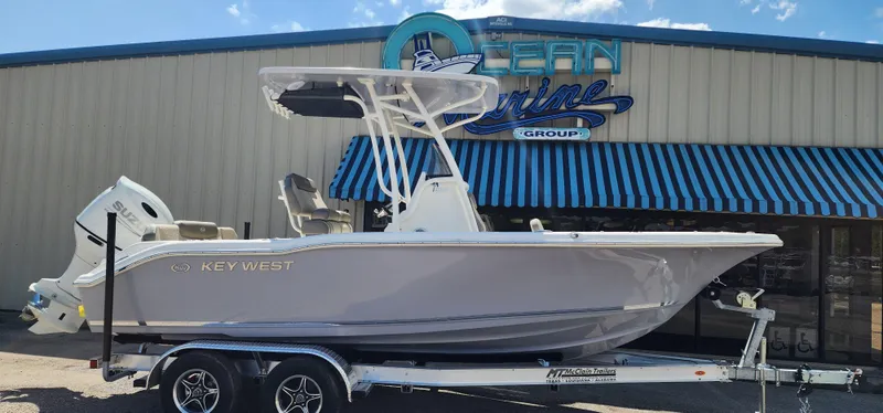 Slide: The Image of 2024 Key West 219fs boat on trailer outside Ocean Marine Group. - 3