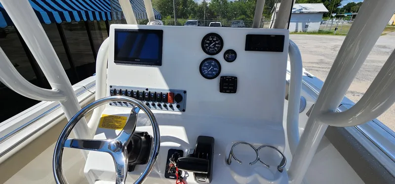 Slide: The Image of 2024 Key West 219fs boat dashboard with steering wheel and control panel. - 30