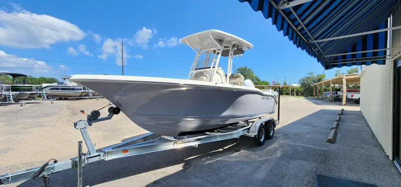 Slide: The Image of 2024 Key West 219fs boat on trailer under blue sky. - 8