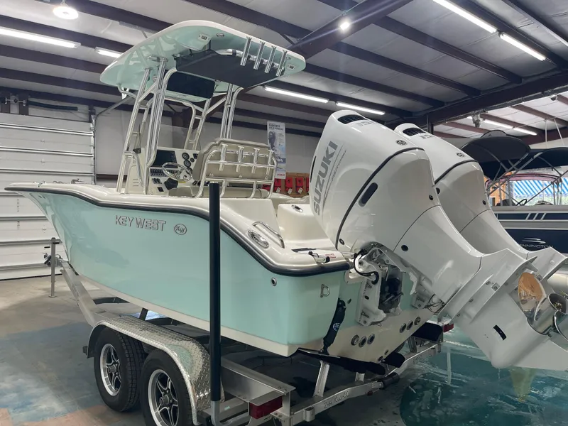 Slide: The Image of 2024 Key West 244CC boat with Suzuki engines on trailer in showroom. - 10