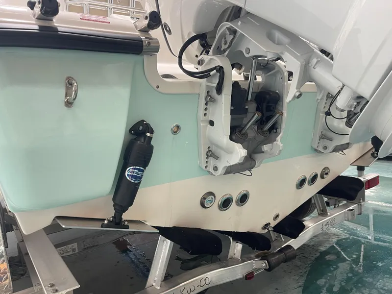 Slide: The Image of 2024 Key West 244CC boat transom with outboard motor mounts on trailer. - 13