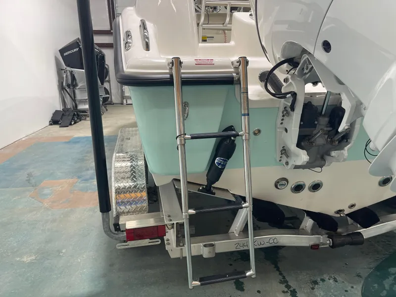 Slide: The Image of 2024 Key West 244CC boat with ladder and trailer in a garage. - 14