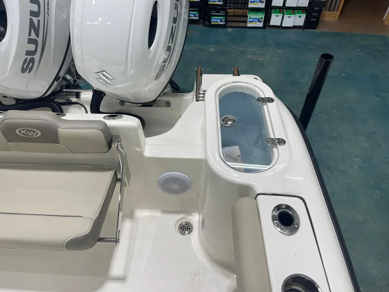 Slide: The Image of 2024 Key West 244CC boat interior with Suzuki engines and seating area. - 16