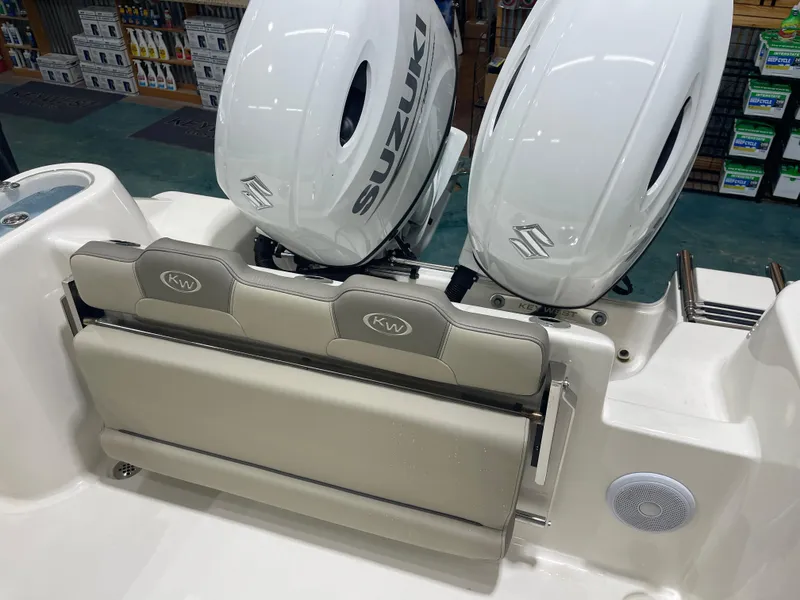 Slide: The Image of 2024 Key West 244CC boat with dual Suzuki engines and foldable seating. - 18