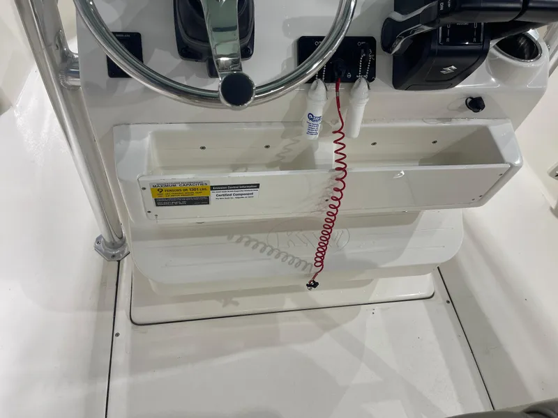 Slide: The Image of 2024 Key West 244CC boat console with steering wheel and controls. - 22