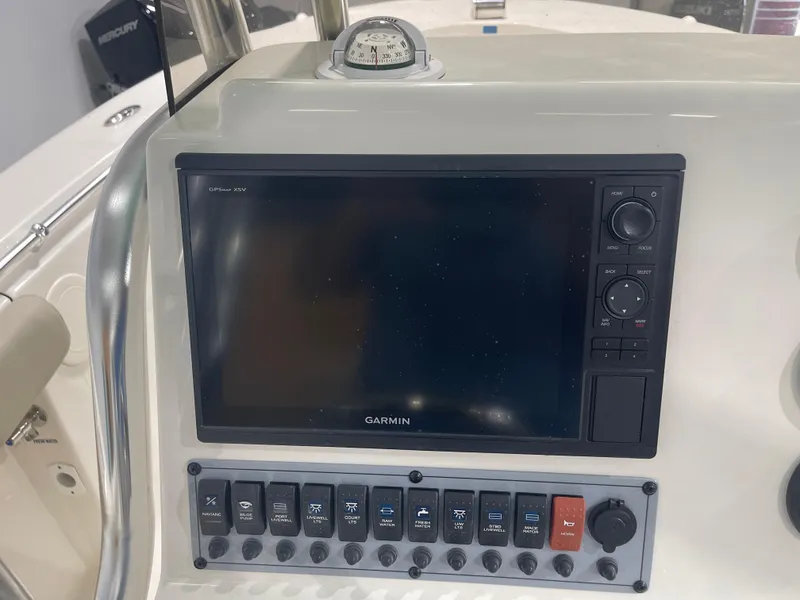 Slide: The Image of 2024 Key West 244CC boat dashboard with Garmin GPS and control panel. - 29