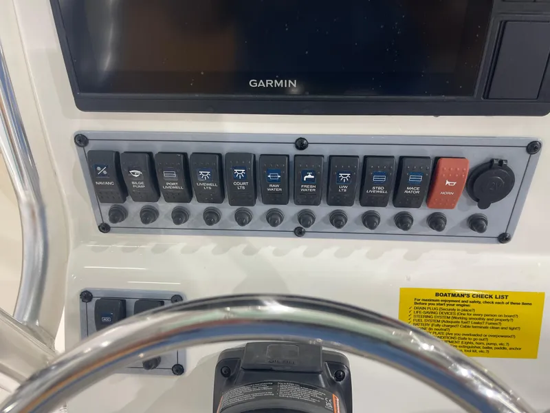 Slide: The Image of Control panel of 2024 Key West 244CC boat with Garmin display and various switches. - 30