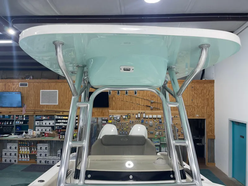 Slide: The Image of 2024 Key West 244CC boat with T-top in a showroom. - 38