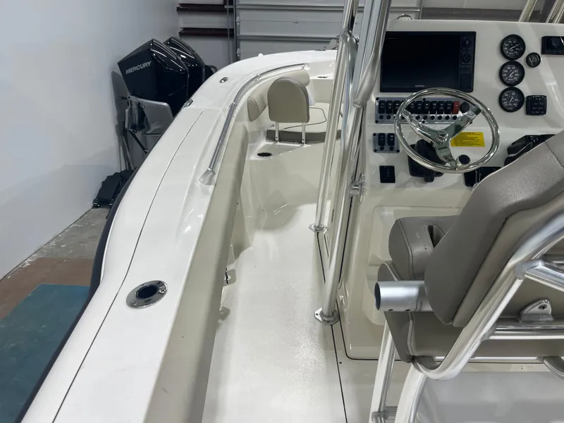 Slide: The Image of 2024 Key West 244CC boat interior with steering console and seating. - 45