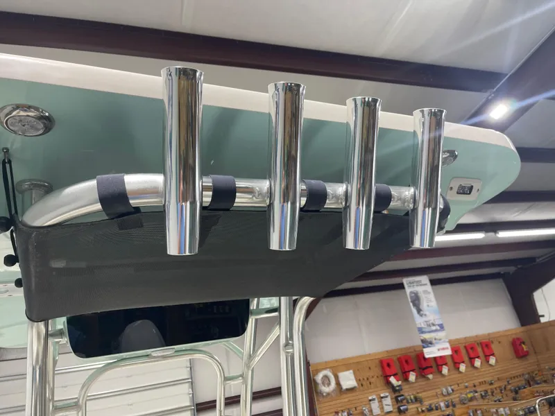 Slide: The Image of 2024 Key West 244CC boat with stainless steel rod holders and T-top in showroom. - 46