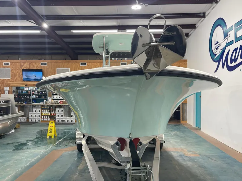 Slide: The Image of 2024 Key West 244CC boat displayed indoors at a marine showroom. - 6