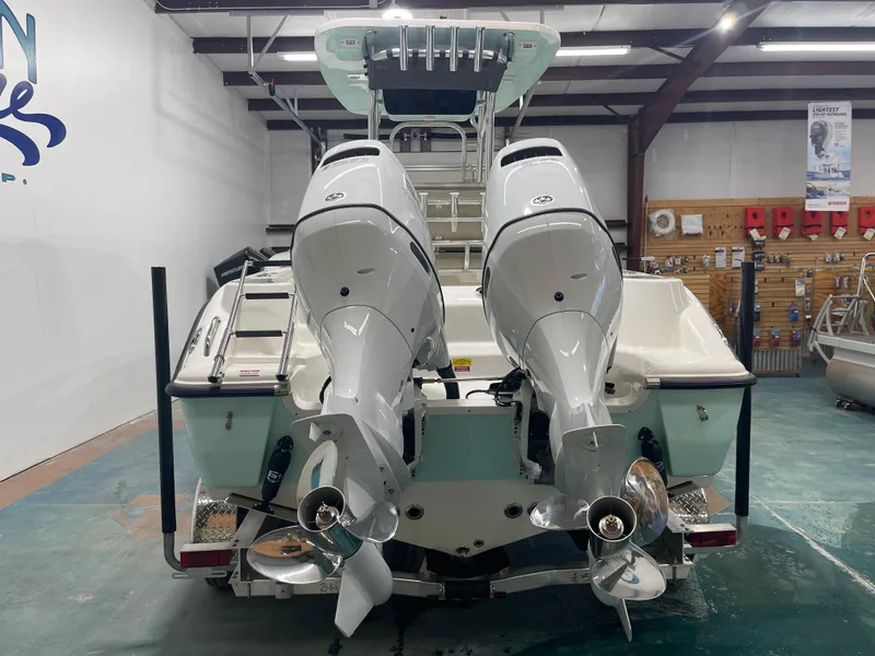 Slide: The Image of 2024 Key West 244CC boat with dual outboard engines in showroom. - 8