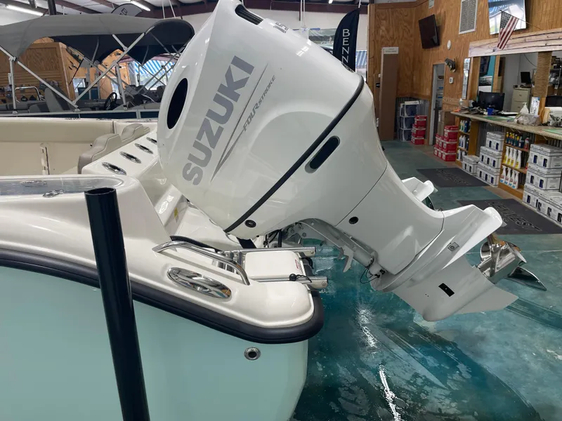 Slide: The Image of 2024 Key West 244CC boat with Suzuki four-stroke outboard motor in showroom. - 9