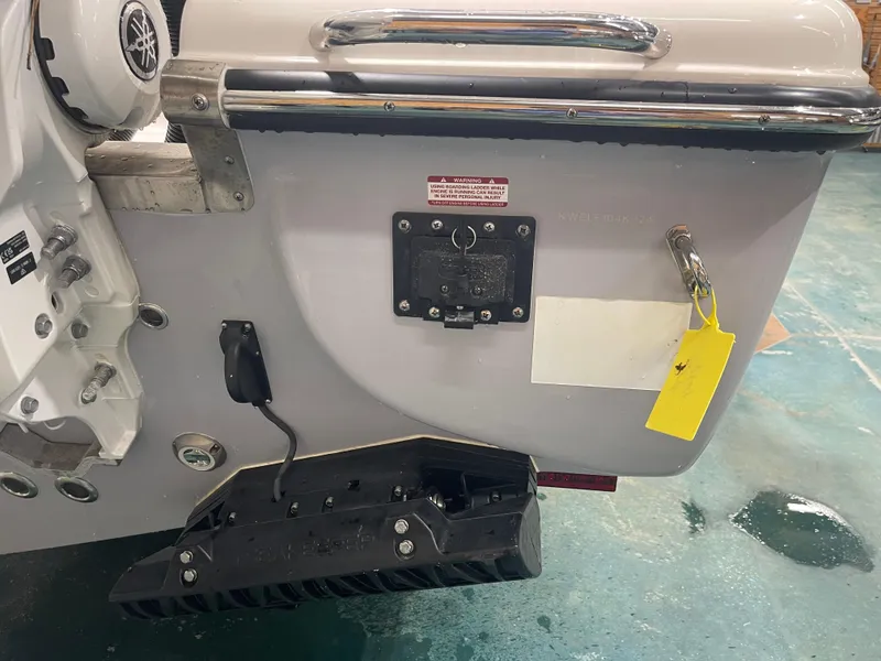 Slide: The Image of 2024 Key West 291FS boat transom with motor mount and safety warning label. - 11