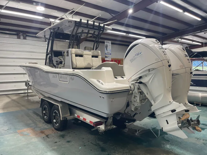Slide: The Image of 2024 Key West 291FS boat with dual Yamaha engines in a showroom. - 12