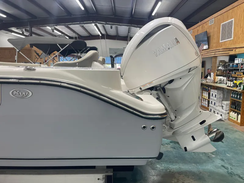 Slide: The Image of 2024 Key West 291FS boat with Yamaha outboard motor in showroom. - 13