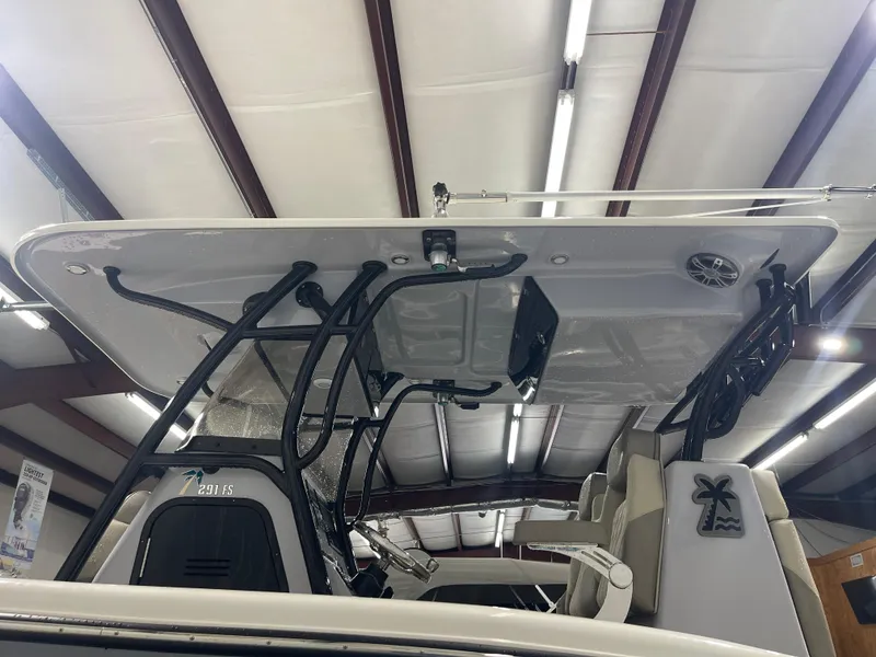 Slide: The Image of 2024 Key West 291FS boat interior with T-top and seating in a showroom. - 15