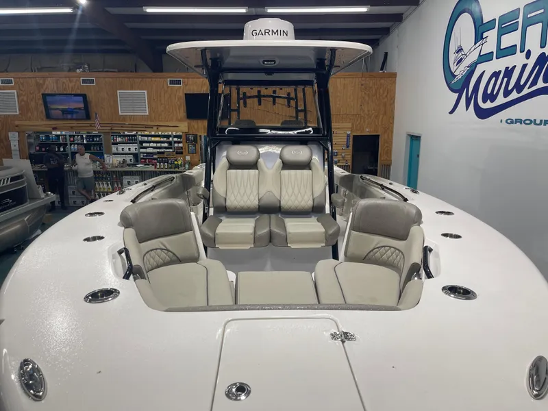 Slide: The Image of 2024 Key West 291FS boat interior with seating, displayed at Ocean Marine showroom. - 18