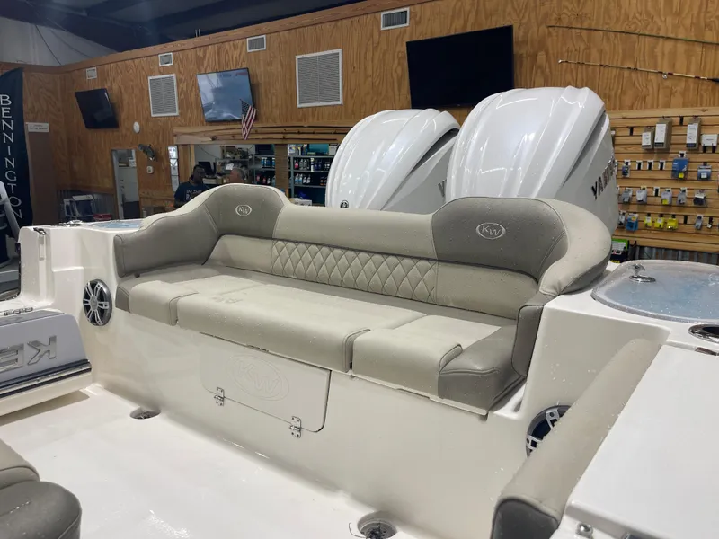 Slide: The Image of 2024 Key West 291FS boat interior with cushioned seating and dual Yamaha engines. - 19