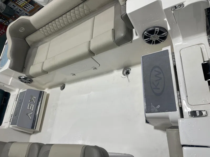 Slide: The Image of 2024 Key West 291FS boat interior with cushioned seating and speaker system. - 21