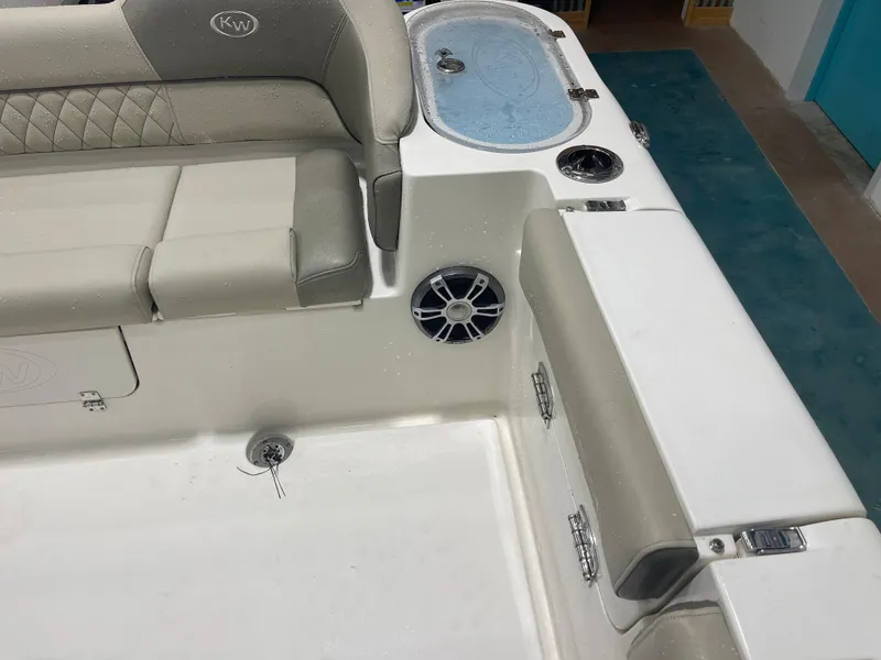 Slide: The Image of 2024 Key West 291FS boat interior with cushioned seating and built-in speaker. - 23