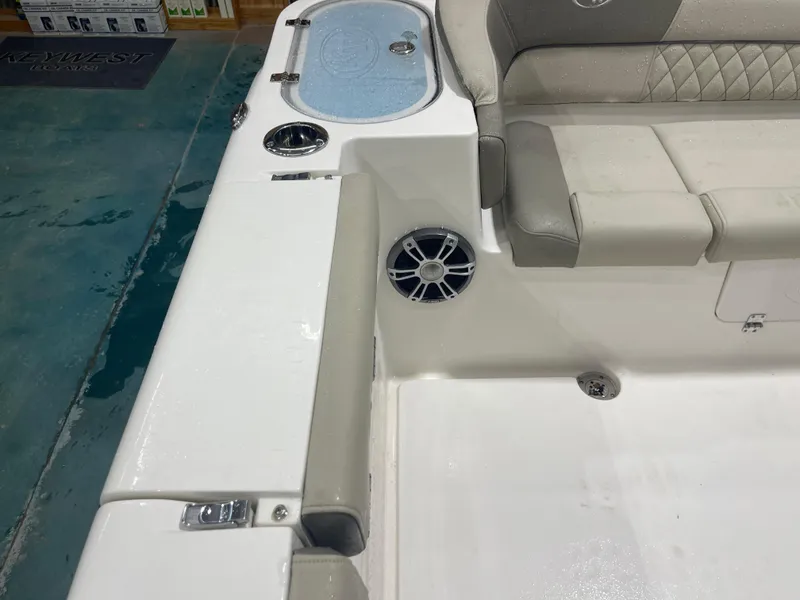 Slide: The Image of 2024 Key West 291FS boat interior with seating and speaker detail. - 24