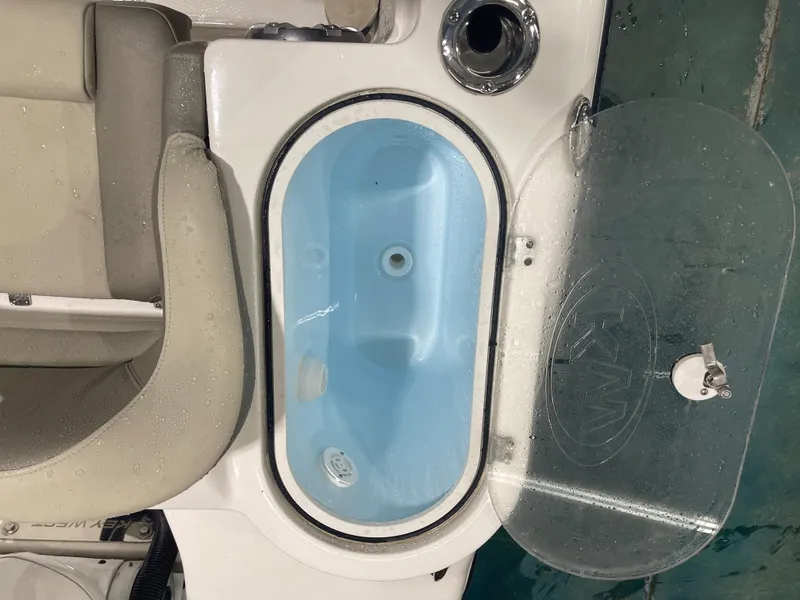Slide: The Image of 2024 Key West 291FS boat livewell with open lid, showing interior details. - 26