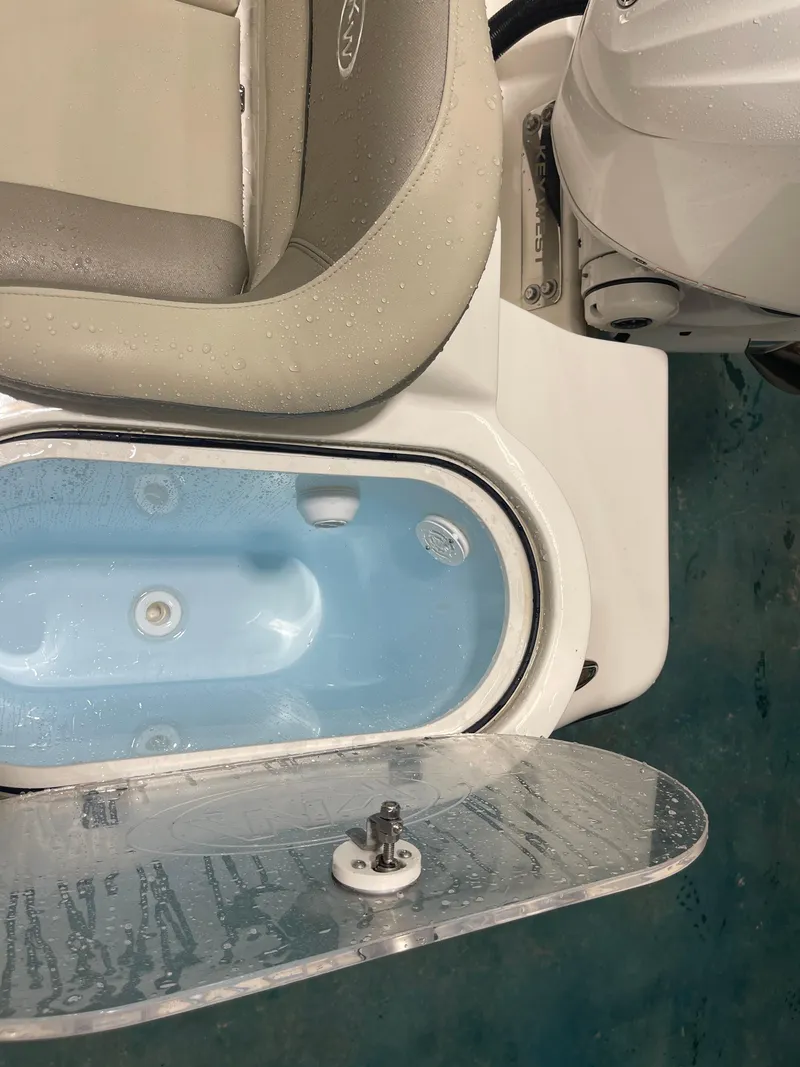 Slide: The Image of 2024 Key West 291FS boat livewell with cushioned seat and motor detail. - 28
