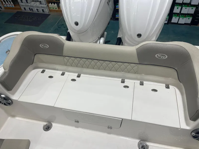 Slide: The Image of 2024 Key West 291FS boat interior with cushioned seating and storage compartments. - 30