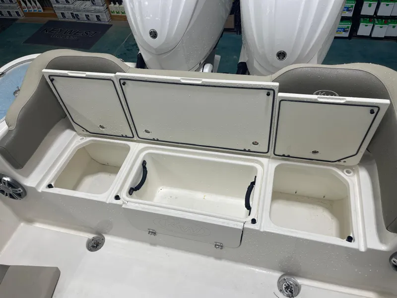 Slide: The Image of 2024 Key West 291FS boat storage compartments with open lids. - 31